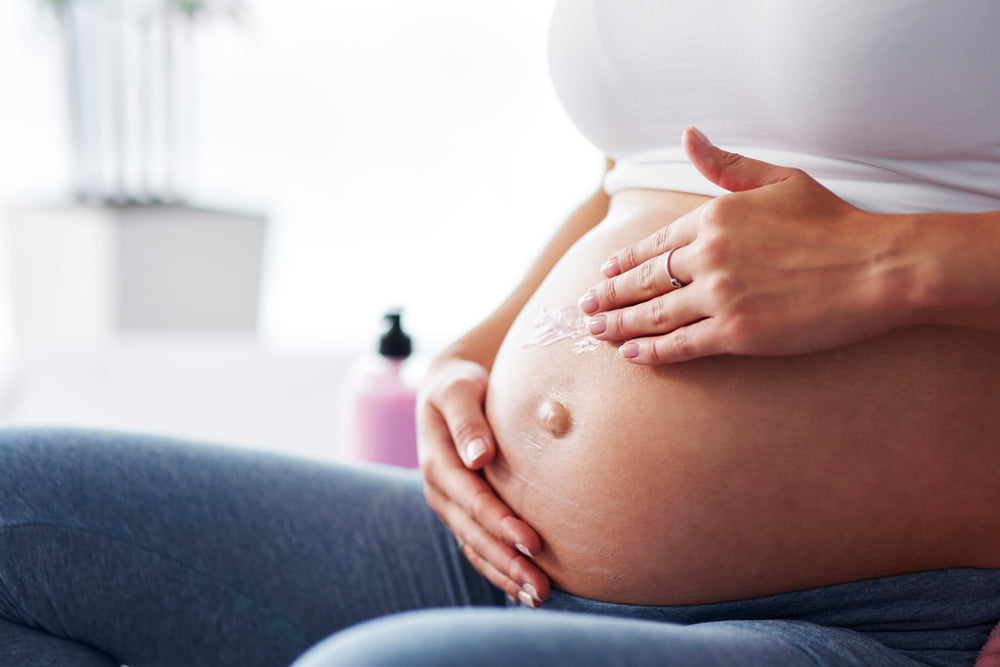  Woman moisturising her itchy skin during pregnancy 