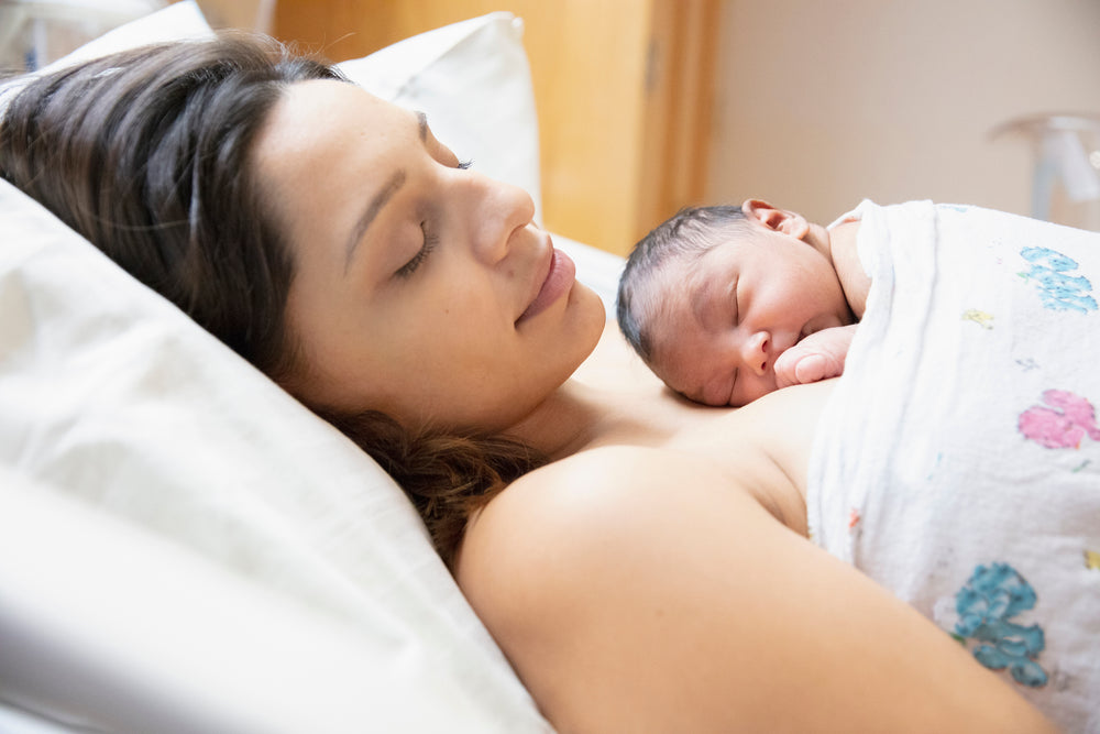  newborn sleeping on mother 