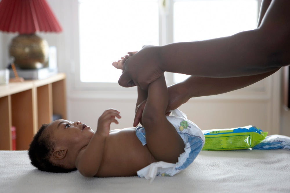  A baby with nappy rash having his nappy changed. 