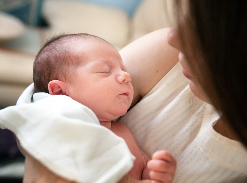  A newborn baby being held by its mother who is keen to improve its microbiome. 