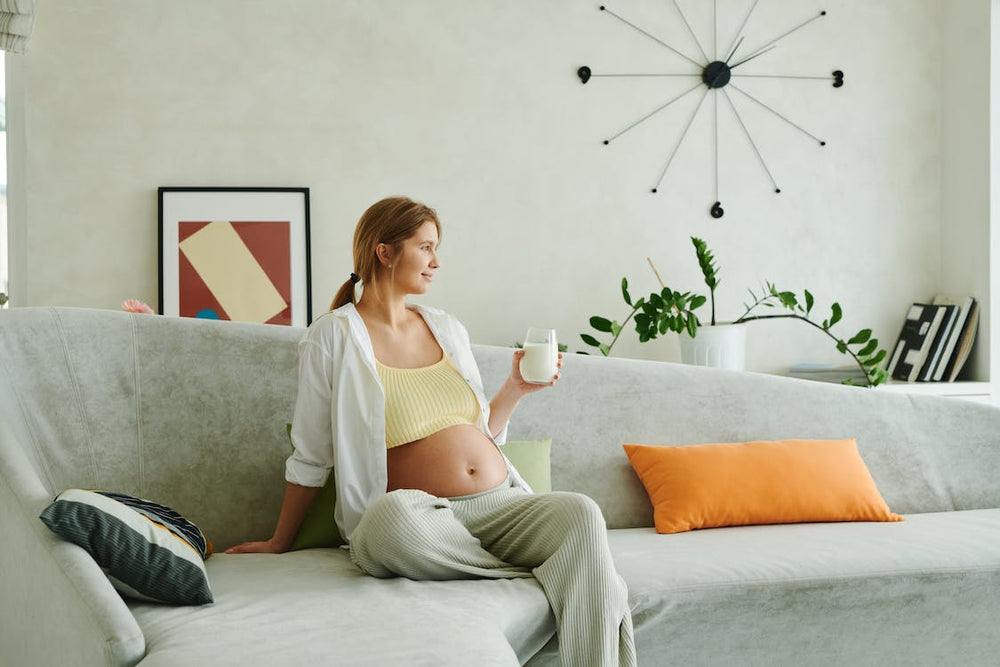  Pregnant woman drinking milk. Calcium in pregnancy is good for the baby and pregnant mothers. 